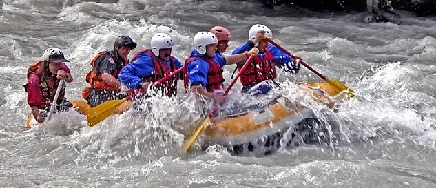 Team paddling in raft