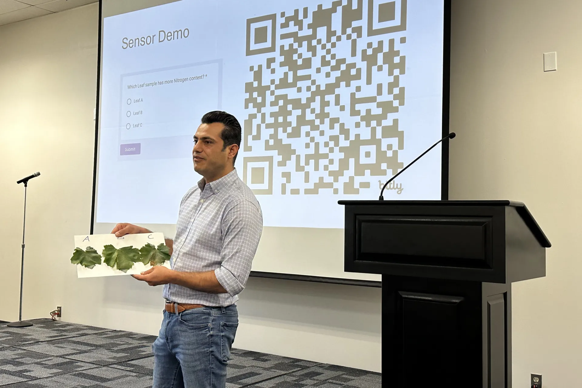 Ali Pourreza holds up three leaves and asks the audience to choose the one with greatest nitrogen content