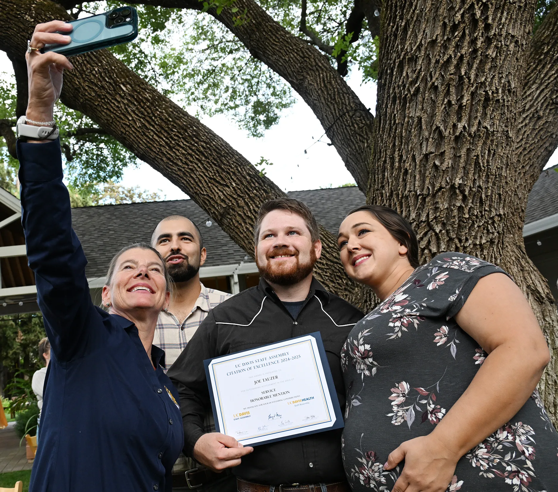 Dean Ashley Stokes of the UC Davis College of Agricultural and Environmental Sciences, captures a selfie with, Kian Nikzad, co-program manager of the UC Davis-based California Master Beekeeper Program and a co-nominator; award recipient Joseph Tauzer and his wife, Kate. (Photo by Kathy Keatley Garvey)