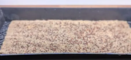 Growing tray with a hemp mat on top of it.