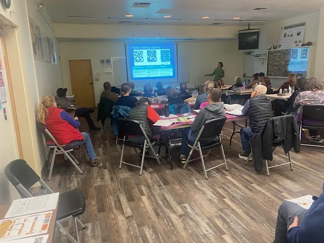 classroom of students with and instructor talking about a topic