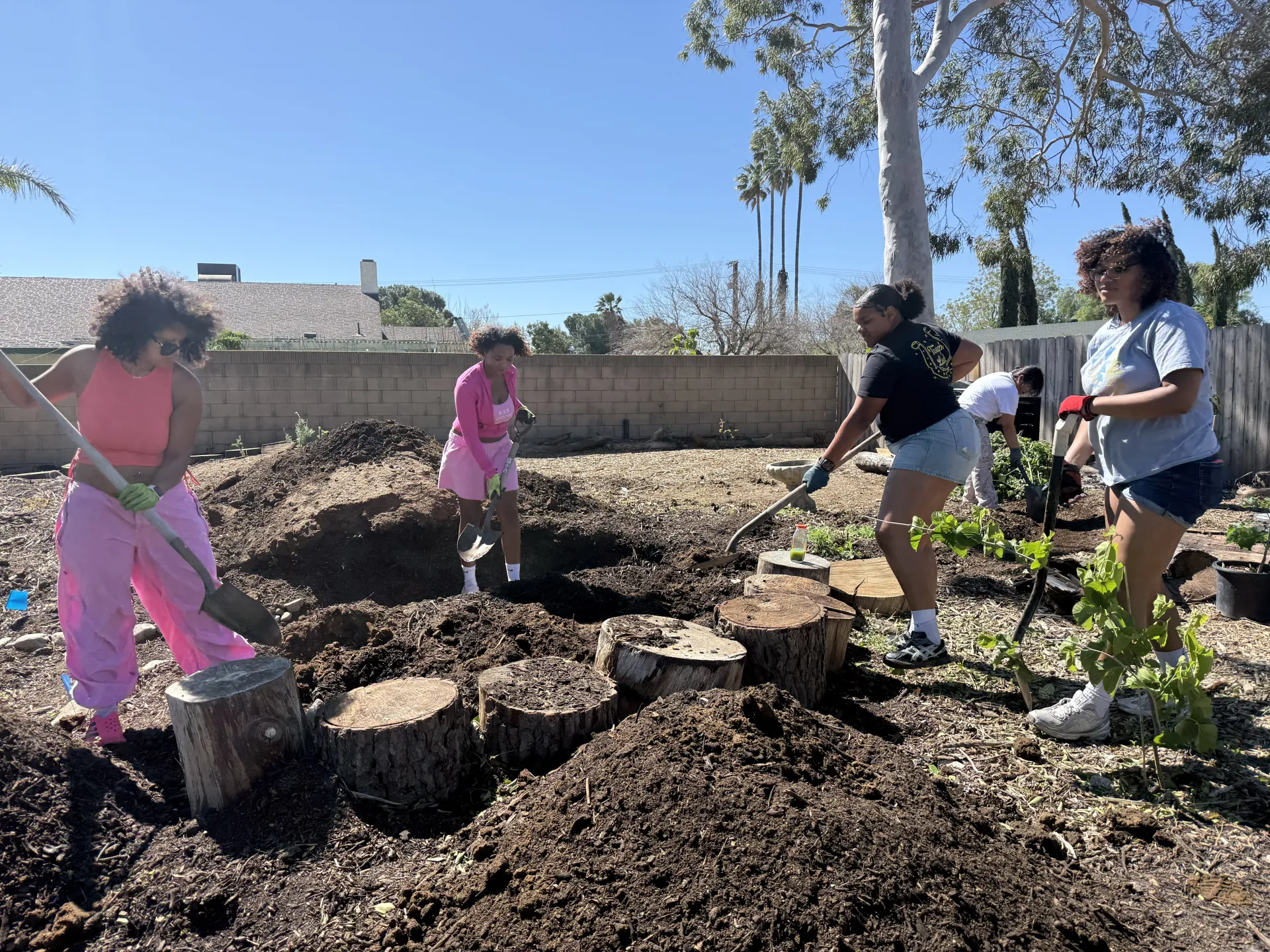 People dig up soil to build a community garden