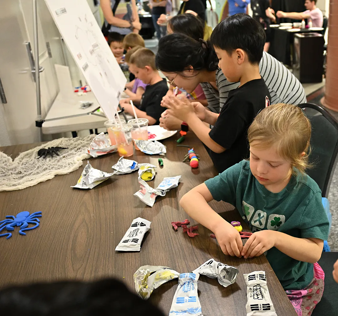 Dorothy Patton, 8, of Woodland concentrates on making her arachnid. (Photo by Kathy Keatley Garvey)