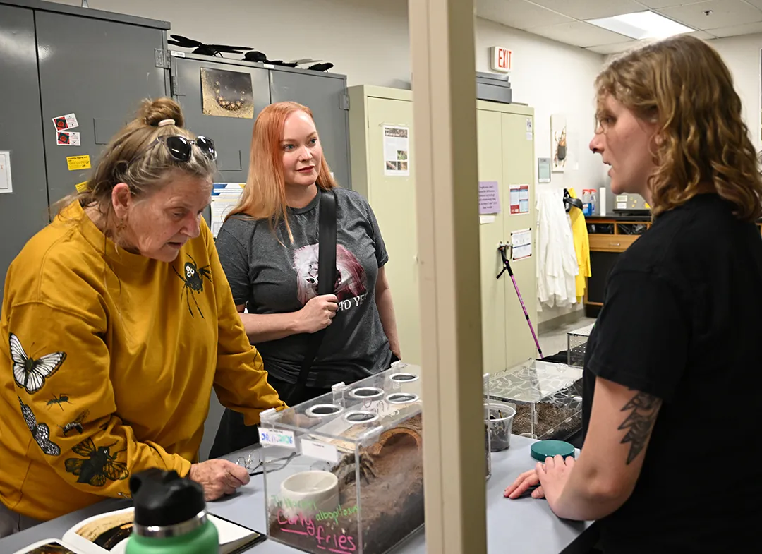 Doctoral candidate Emma "Em" Jochim (right) chats with Valdis Boven (left) of White Salmon, Wash., and Nancy Duley of Fairfield. (Photo by Kathy Keatley Garvey)