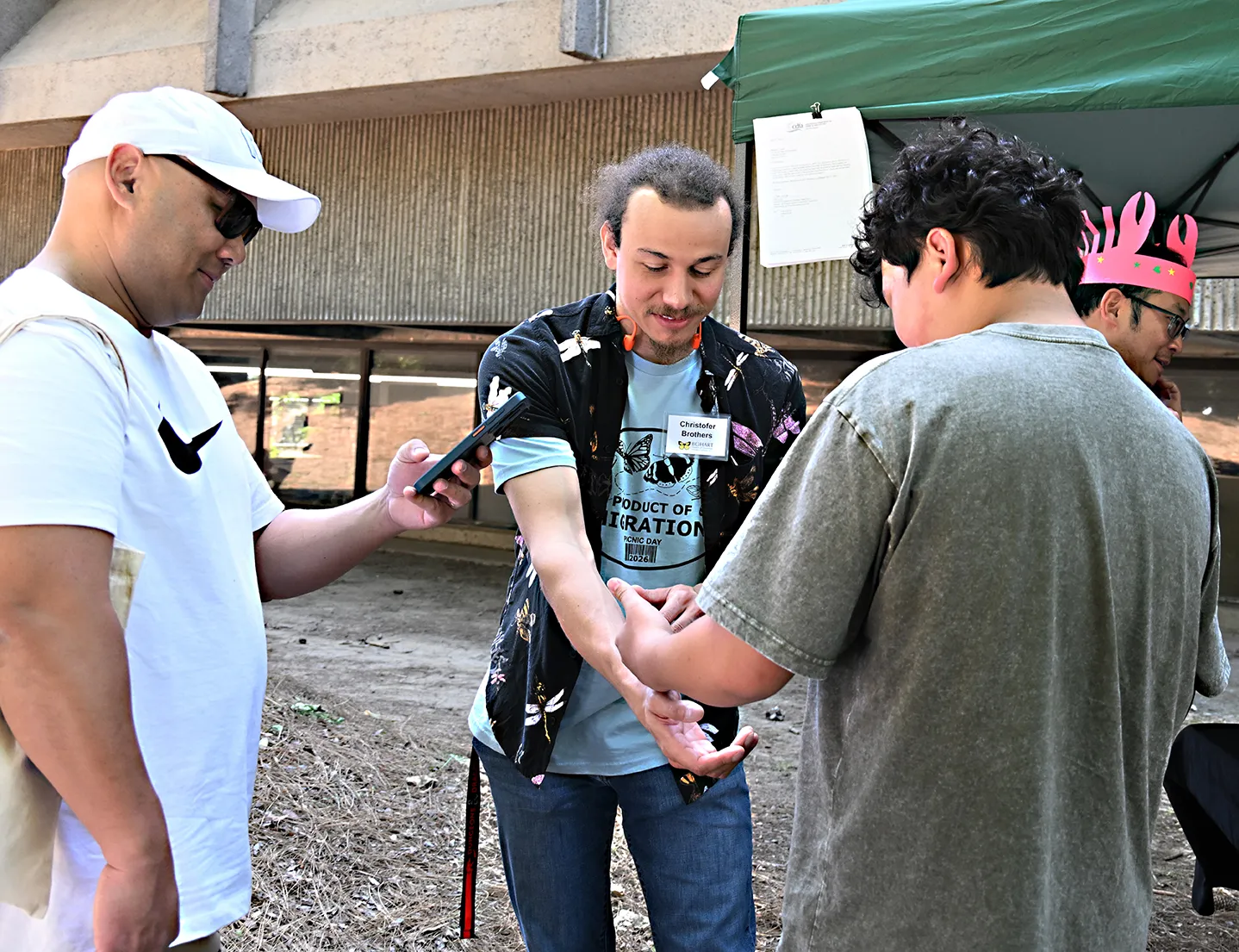 Doctoral candidate Cristopher Brothers showing insects to the crowd.