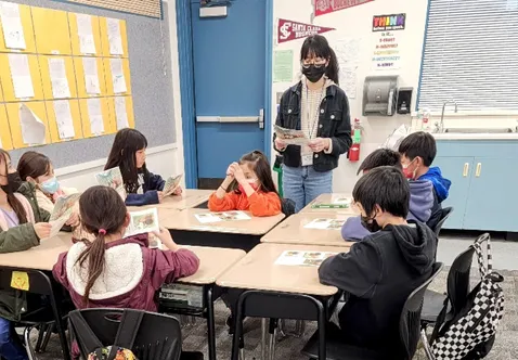 Teen Teacher Annie guides Cooking Academy students through Lesson 3: Crispy Black Bean & Vegetable Quesadilla, where students learn knife skills and safe can opener techniques