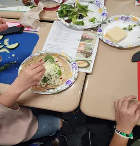 4th-6th grade students in Elk Grove follow a recipe and their teen teacher to make delicious and colorful Rainbow Veggie wraps.