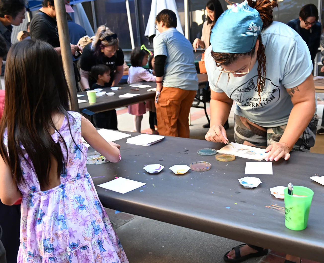 Iris Quayle (foreground) and Sam McCullough leading the maggot art activity.