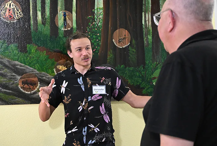 Dragonfly expert Cristopher Brothers answering a question at a Bohart Museum of Entomology open house.