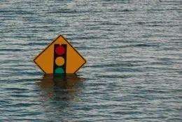 street sign halfway under water due to flood