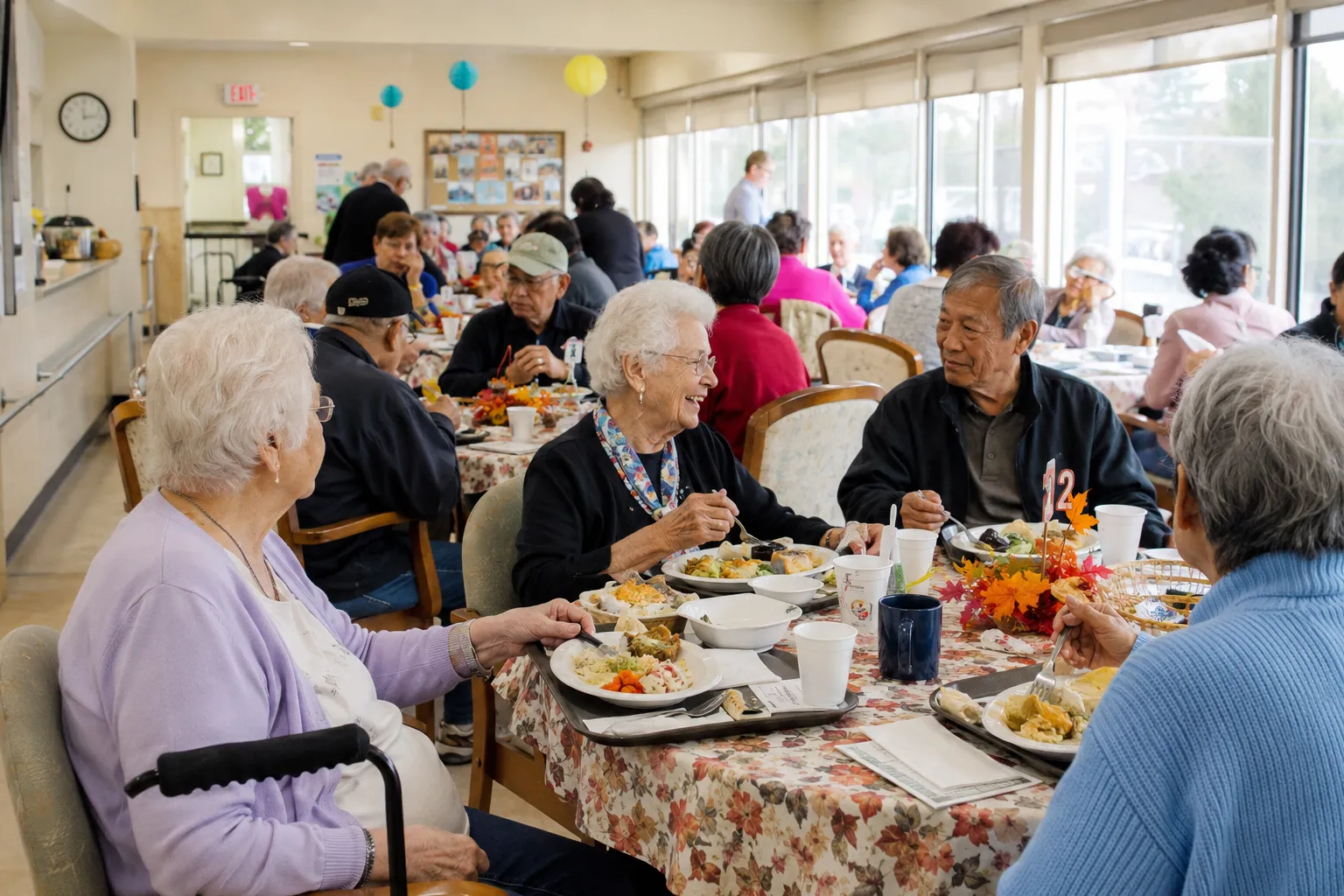 Older adults sharing a nutritious meal and conversation at a welcoming community congregate dining program supporting healthy aging and social connection.
