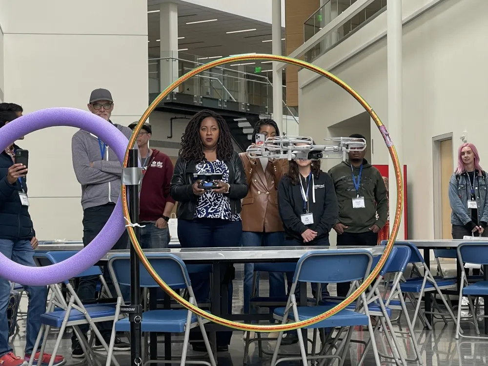 DroneCamp 2023 Participants flying mini drones thru hoola-hoops