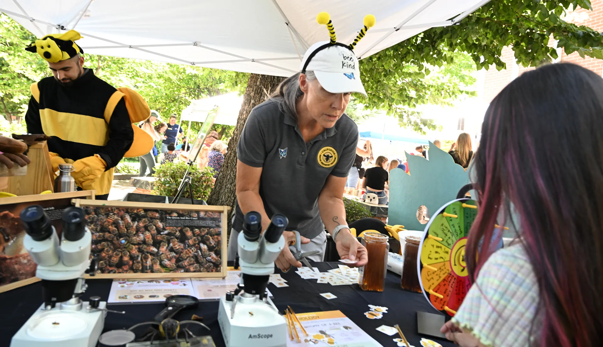 Kian Nikzad (left) and Wendy Mather, co-program managers of the California Master Beekeeper Program, staffing an outreach booth.