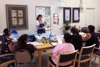 teacher discussing food with adult students
