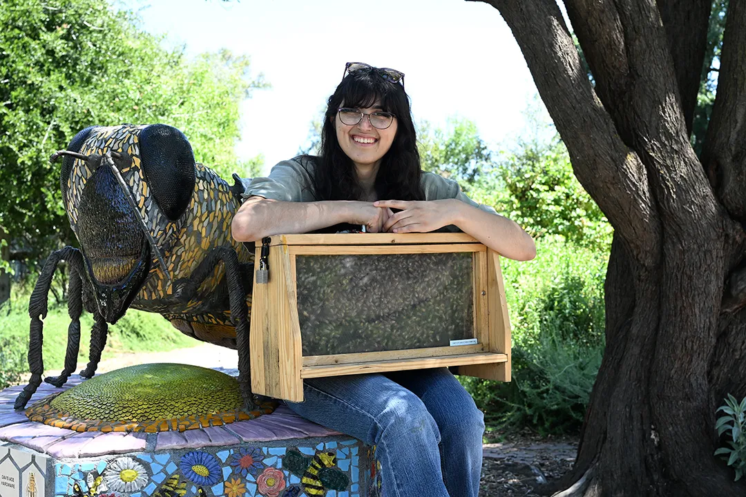 Samantha "Sam" Murray holding an observation hive at the UC Davis Bee Haven.