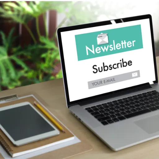 Request to subscribe to our newsletter - computer on desktop with plants behind