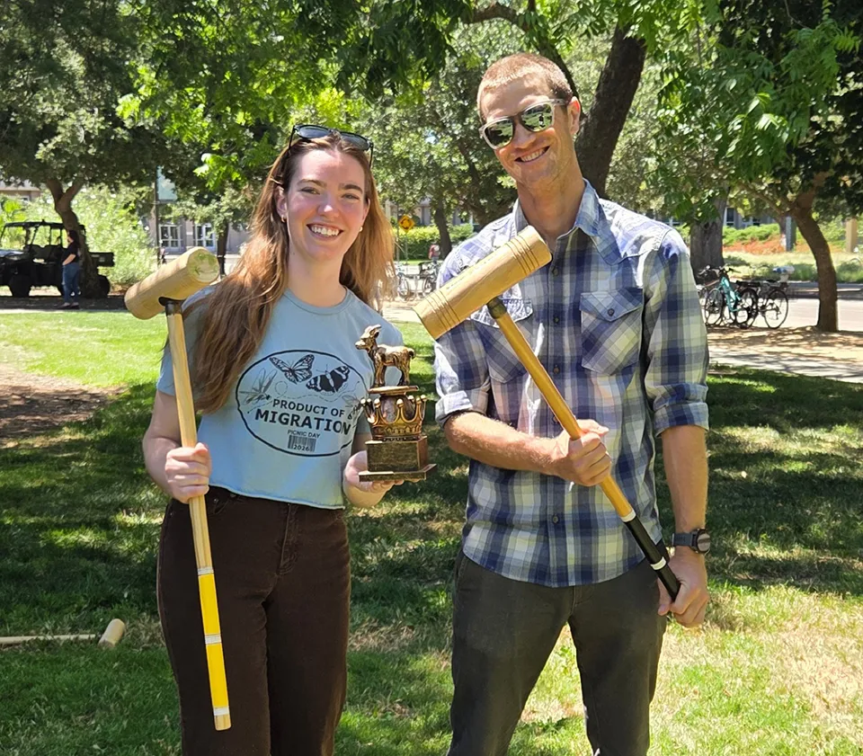 Ian Grettenberger and doctoral student Briley Mullin display their GOAT (Greatest of All Time) trophy after winning the Graduate Student-Faculty Retreat Croquet Game.