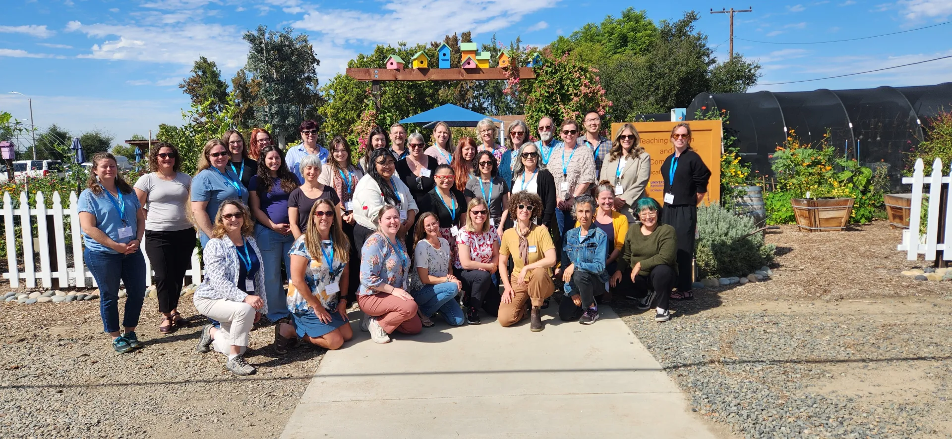 A large group of people near a garden.