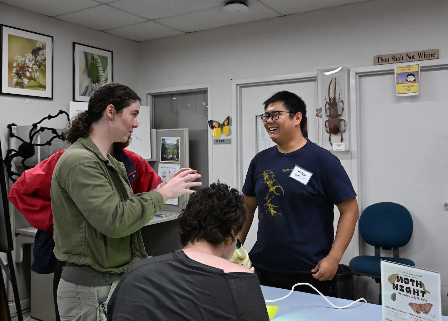 Doctoral student Kaitai Liu of the Jason Bond lab shares moth information with the crowd. (Photo by Kathy Keatley Garvey)