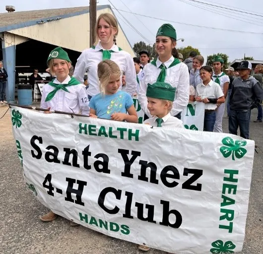 youth holding their club banner