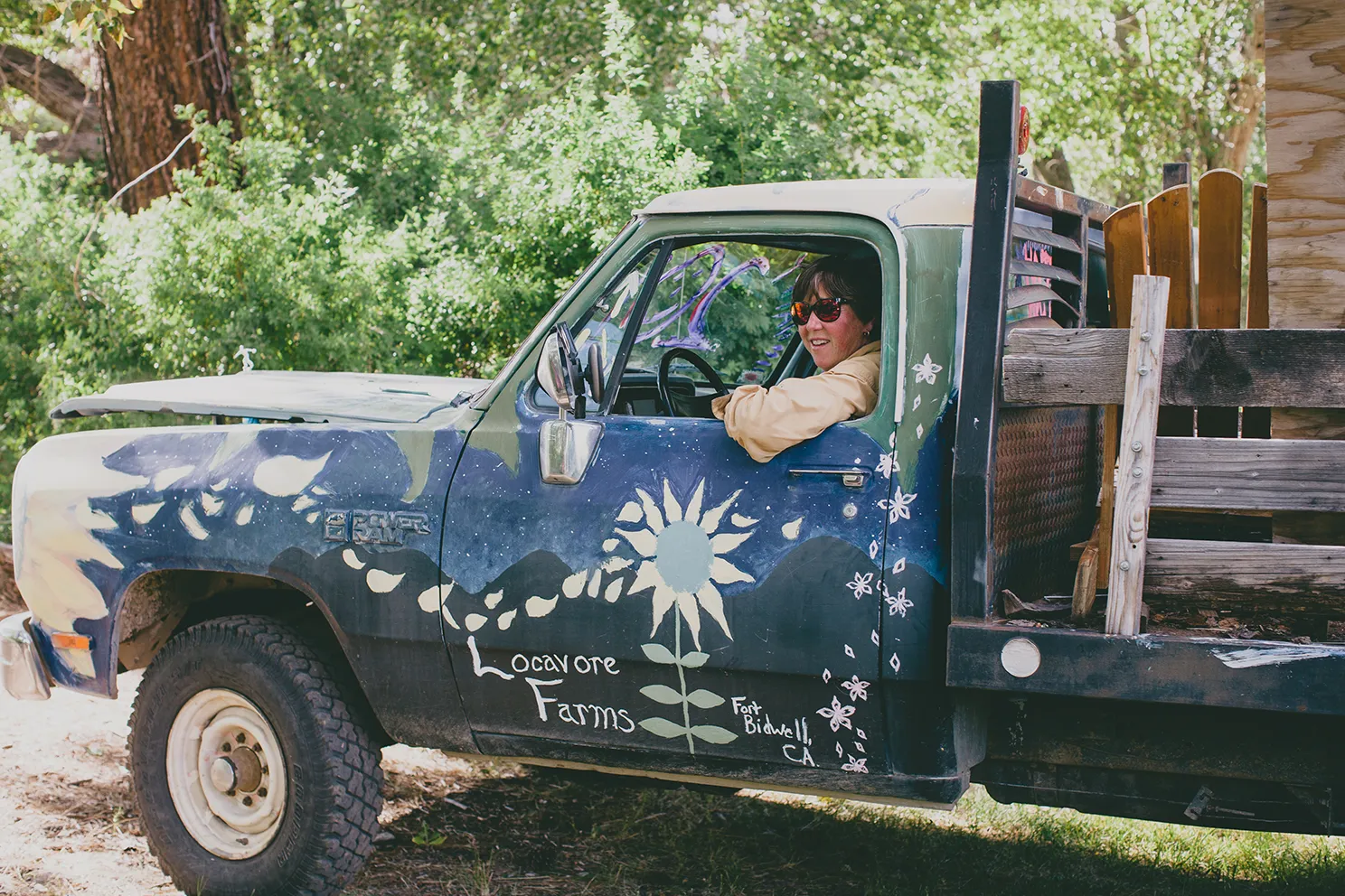 Laurie "Lio" Wayne leans out the driver's side window of a truck at her Locavore Farms