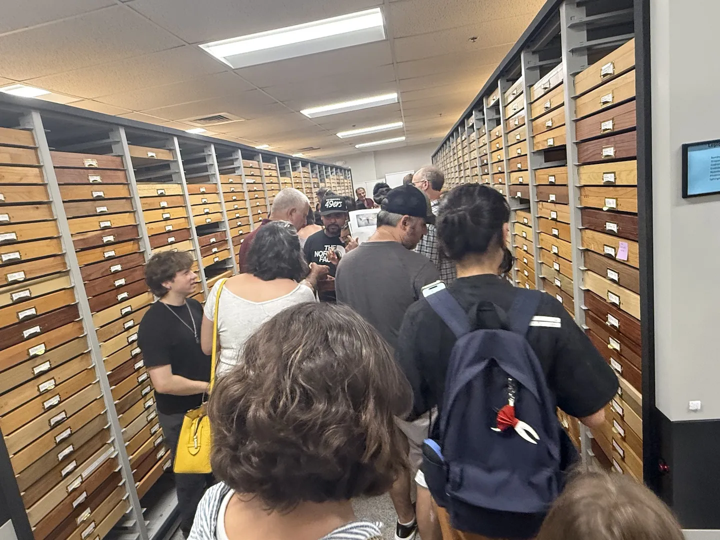Jeff Smith (in maroon shirt) fields questions about moth specimens.
