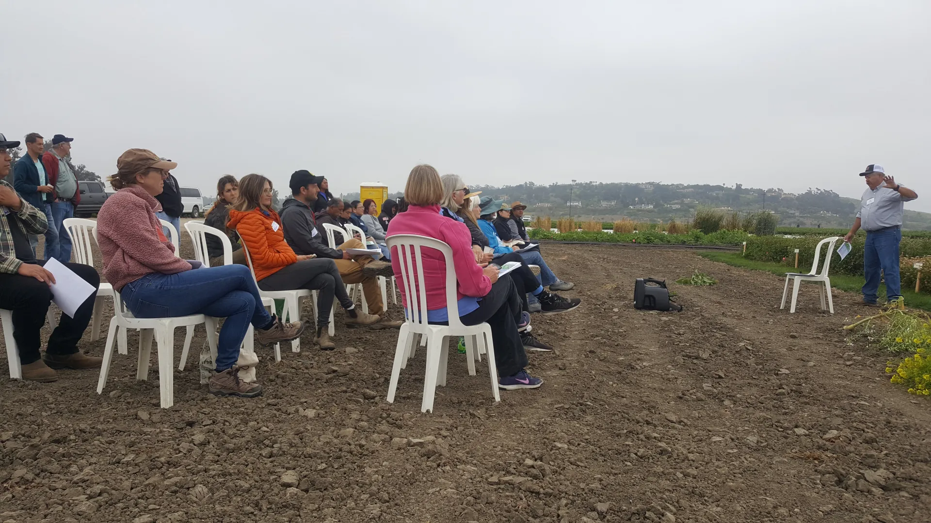 Man talking to group of people in field