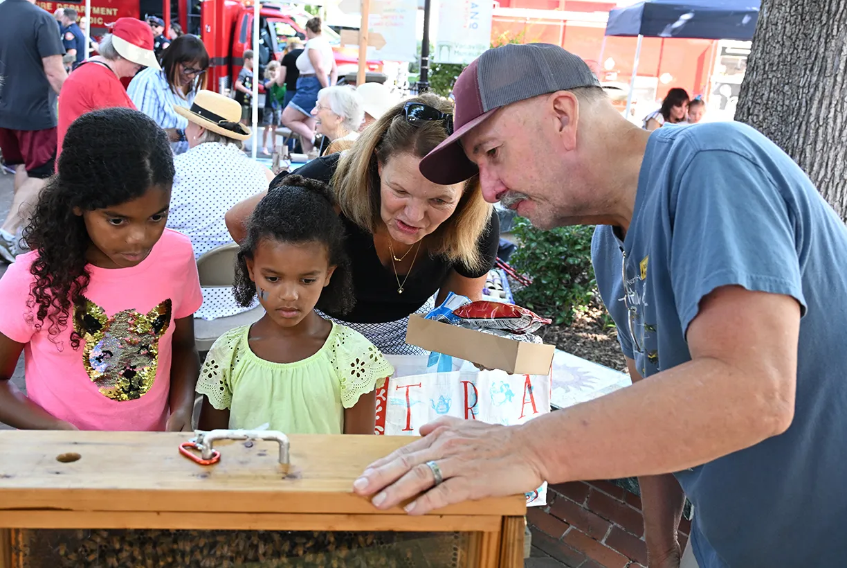 Rick Moehrke of Vacaville, a member of the California Master Beekeeper Program, shows guests the bee observation hive.