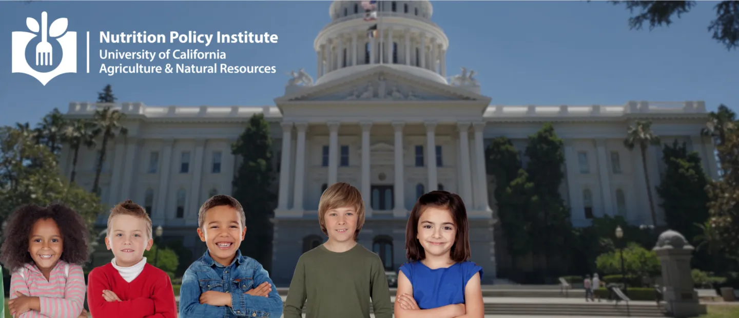 A group of children standing in front of the capitol building.