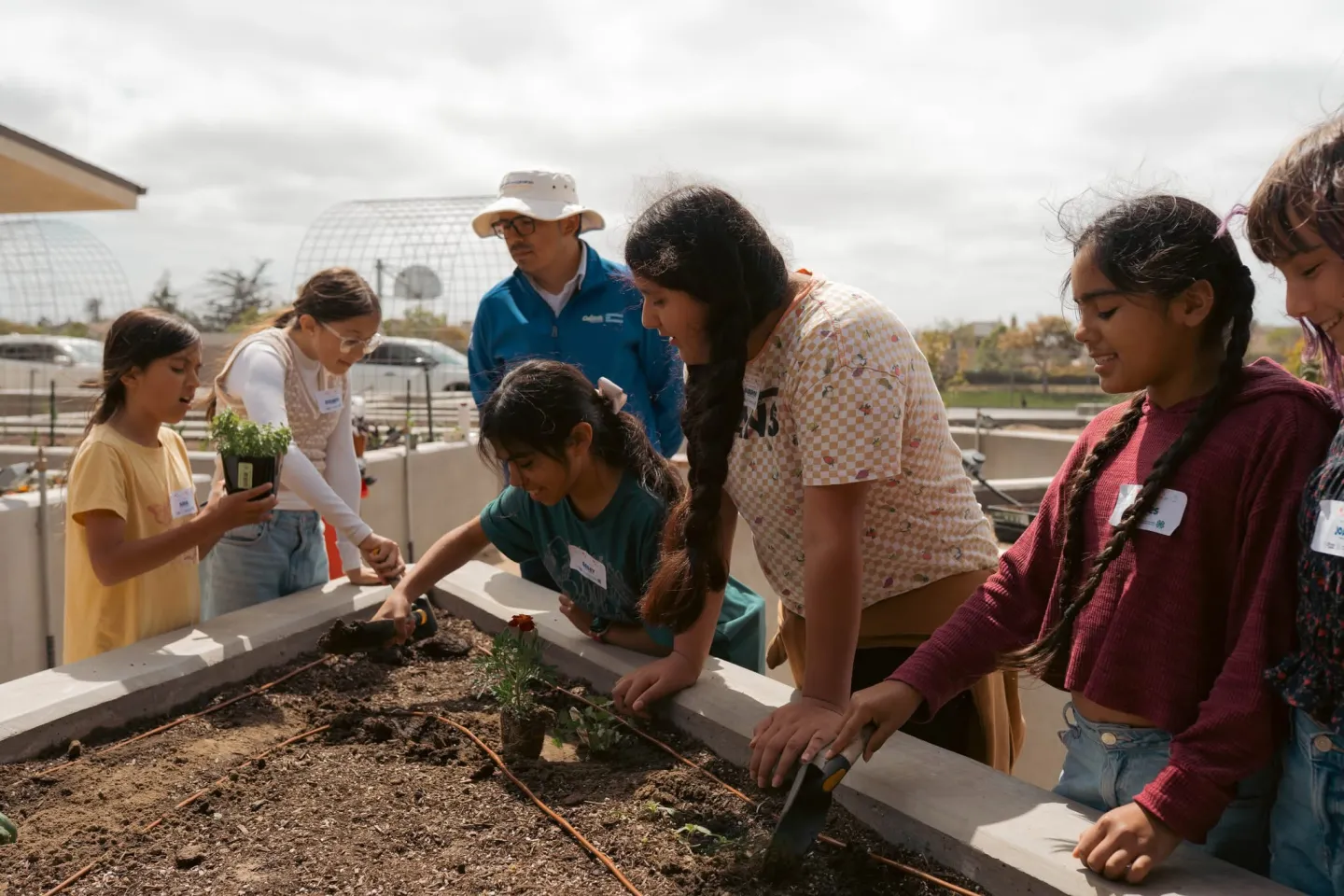 SNAC students and CalFresh Healthy Living staff working on garden