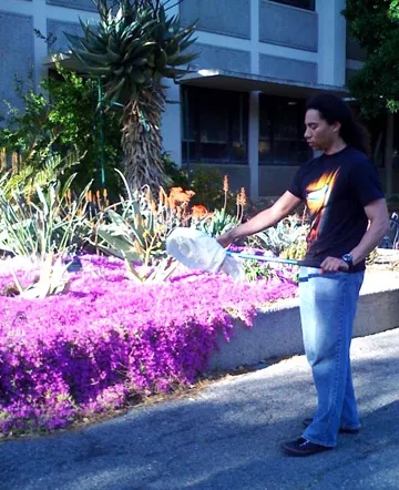 Ralph Washington, now a graduate student in entomology at UC Davis, was one of the students who participating in making the insect-collecting videos. Here he demonstrates how to use a net. (PHoto by Kathy Keatley Garvey)