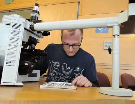 Checking out nematodes is Nematologist Corwin Parker, a UC Davis graduate student in nematology, UC Davis Department of Entomology and Nematology. He will be talking nematodes at a display in the Sciences Lab Building. (Photo by Kathy Keatley Garvey)