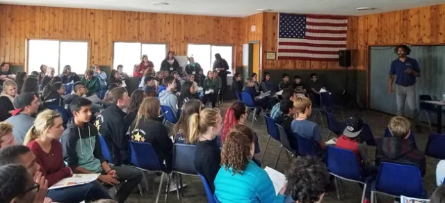 Derek Robinson, 4-H academic coordinator for Money Talks, discusses how to budget money with attendees.