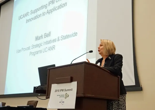 UC IPM academic coordinator Lori Berger introduces UC ANR vice provost Mark Bell at the IPM Summit.