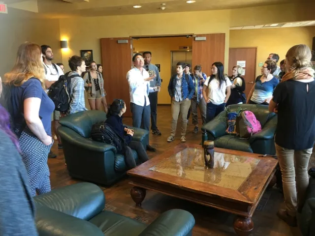 Bennett Peji of the Jacobs Center (left of center in white shirt) discuss economic justice with GFI fellows. “Our role is to convene partners, create models that work and see how nonprofits can better serve the community,” Peji said.