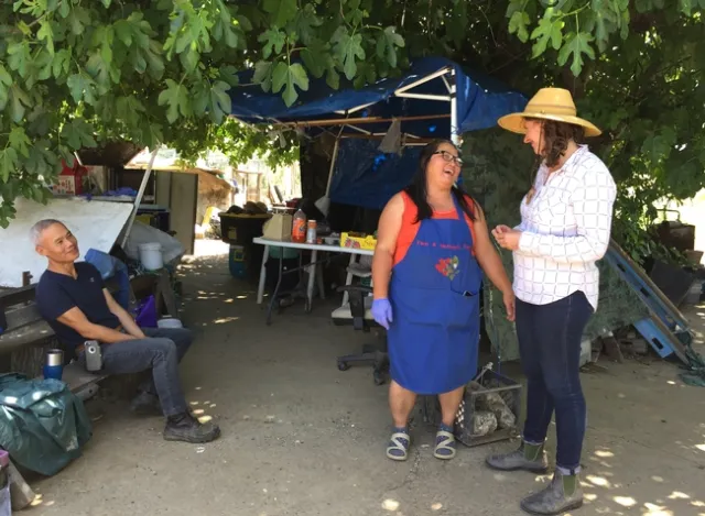 Visiting Mien farms makes it easier for Lloyd, right, to demonstrate practices for farmers who aren't fluent in English.