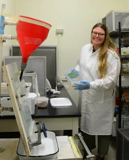 Medical entomologist Olivia Winokur holds a tray of Culex tarsalis larvae in the insectary, UC Davis School of Veterinary Medicine. The Chris Barker lab has nine colonies of mosquitoes in the insectary. (Photo by Kathy Keatley Garvey)