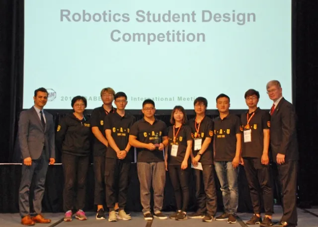 Ali Pourreza, left congratulates China Agricultural University's Dream Team, winner of the ASABE robotics challenge advanced division.