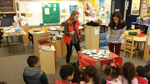 UC CalFresh coordinator Hannah and I serving a spinach, radish, and cilantro tasting fresh from the students' garden