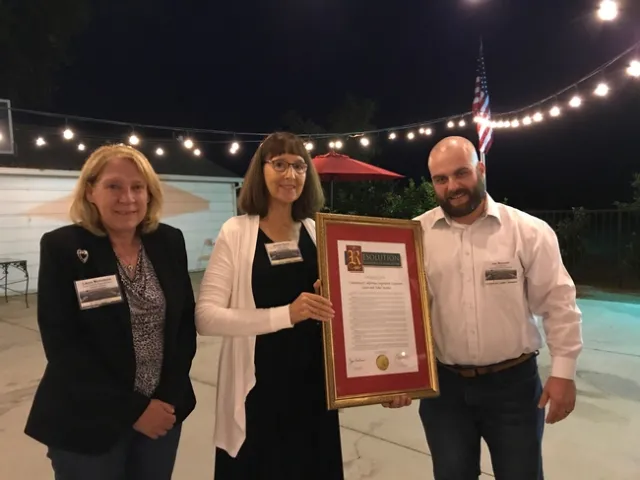 In recognition of UCCE Sutter-Yuba's centennial, Janine Hasey was presented a Senate/Assembly Resolution by Laura Nicholson, senior district representative for state Senator Jim Nielsen, and Joe Brennan, who represented Assemblymember James Gallagher.