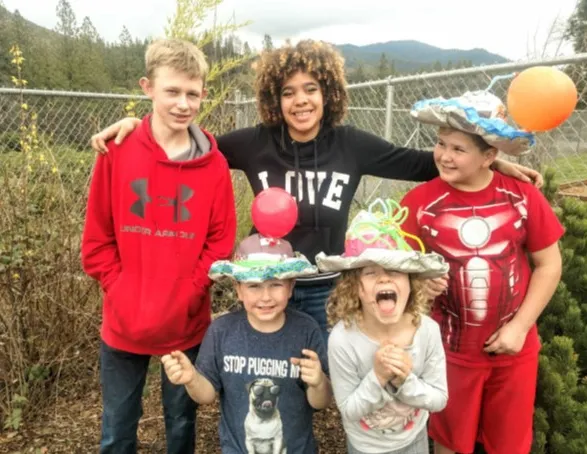 Macy Senter (center in black “LOVE” shirt) with students in the afterschool program.