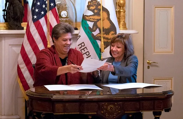 UC ANR vice president Glenda Humiston (left), and California Secretary of Agriculture Karen Ross sign a memorandum of understanding to initiate the new partnership to advance climate-smart agriculture.