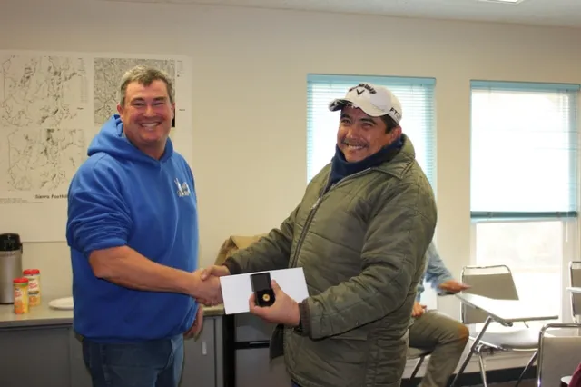 Abraham Mendoza accepts his 25 year service pin.