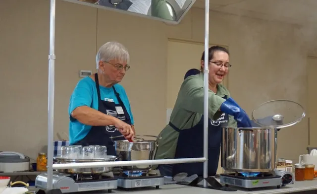 Master Food Preserver volunteer Barbara Mattice, left, helps Master Food Preserver coordinator Sue Mosbacher conduct a food preservation class.