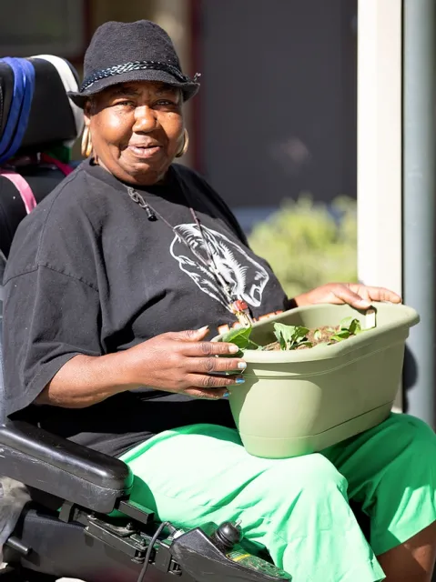Gardening participant planting herbs