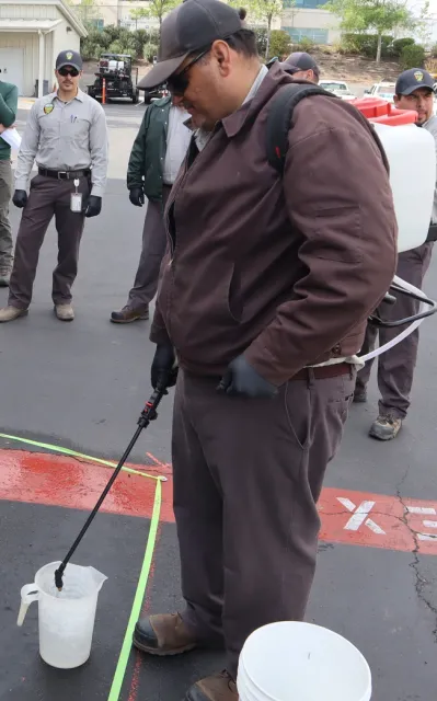 Figure 1. Backpack sprayer pesticide calibration. (Credit: G. Del Rosario, Corteva)