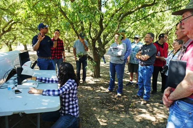 Rijal set up a microscope with an oversized monitor in the field to show participants insect details.