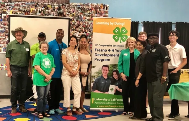 4-H community educator Alena Pacheco (in green jacket), introduced Regent Estolano (in white pants) and Sen. Caballero (next to Pacheco) to UCCE Fresno partners Street Saints, who offer a safe place for youth after school where they can develop employment skills through 4-H activities.