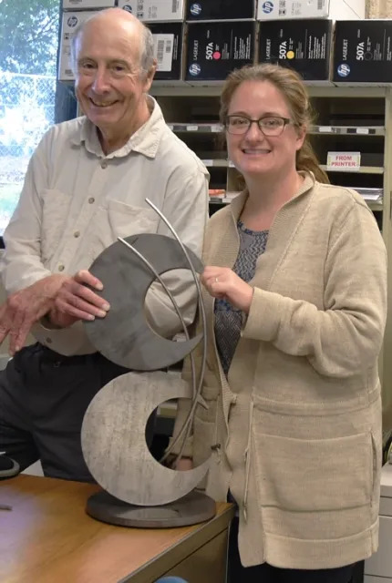 Bruce Hammock, founder and CEO of EicOsis and Cindy McReynolds, senior program manager, with the trophy. (Photo by Kathy Keatley Garvey)