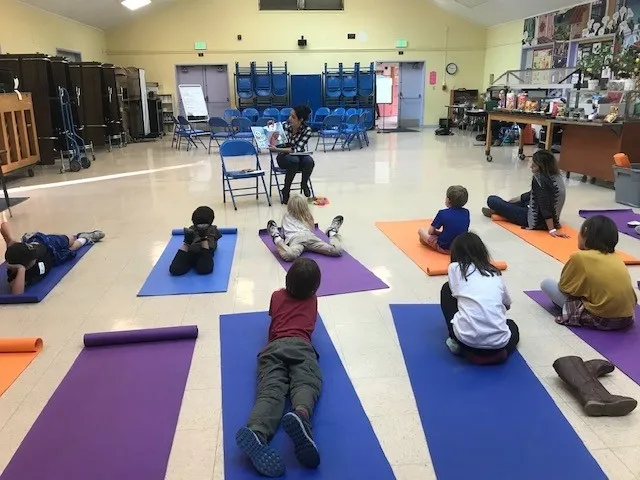 Children listen to stories read by the teen teacher about empathy, managing emotions, and how to improve skills related to attention and focus.